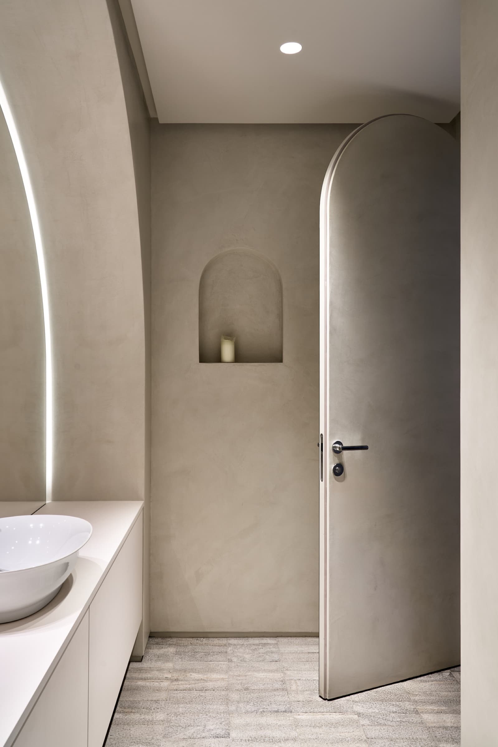 Bathroom with arched door and vessel sink